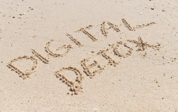 istock Words digital detox written on yellow sand. 1248693764