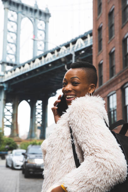 istock Woman in Dumbo - New York talking on mobile 1248695004