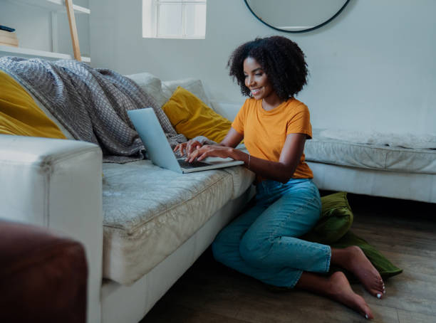 istock Beautiful female sitting in the lounge web browsing on laptop 1248699030