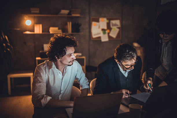 istock Business people working late at night in office 1248699239