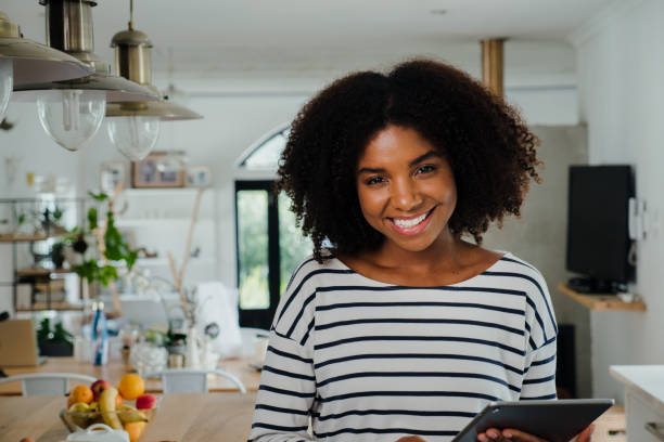 istock Beautiful multi ethnic female portrait in kitchen at home 1248700088