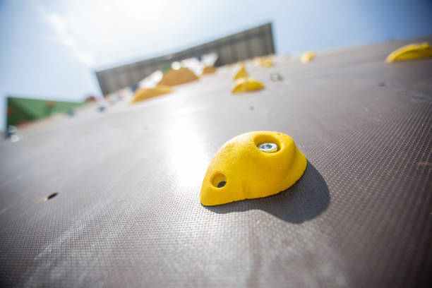 colorful climbing wall rocks for kids on wooden background at playground