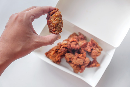 Close up shot of Asian woman snacking Japanese fried chicken karaage