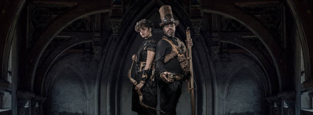 Steampunk couple in a studio shot Steampunk couple of male and female enthusiasts in a studio shot steampunk pistol pictures stock pictures, royalty-free photos & images