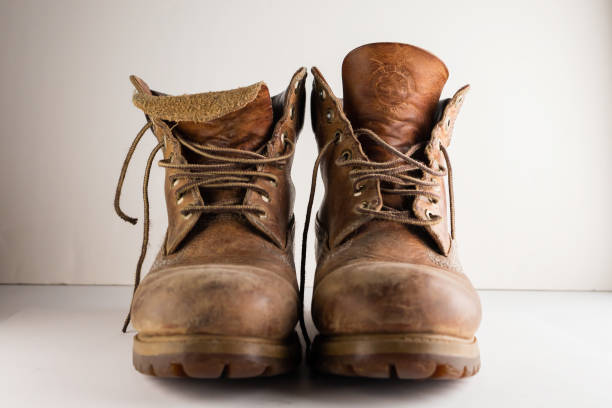 istock Old leather brown boots isolated in a white background. 1248701854