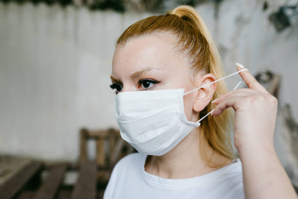istock Young woman putting the mask on her face. 1248702462