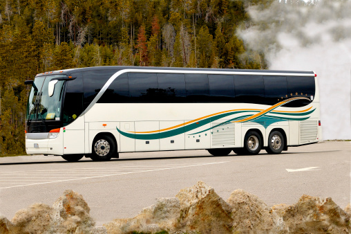 Tour Bus In Yellowstone National Park Geyser Basin.  High Resolution