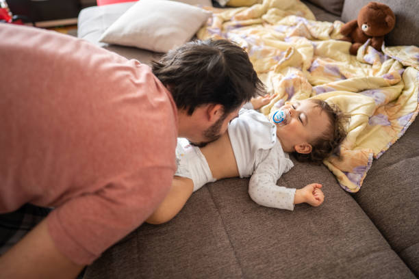 istock Father having fun while dressing up his son at home 1248703845