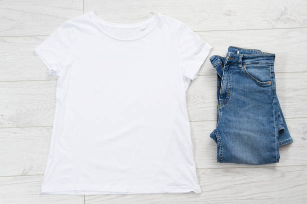 istock White t-shirt mock up top view, and blue denim 1248706676