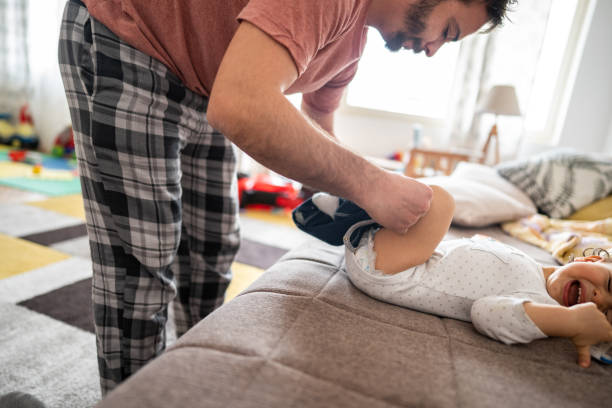 istock Father dressing up his little son at home 1248707084