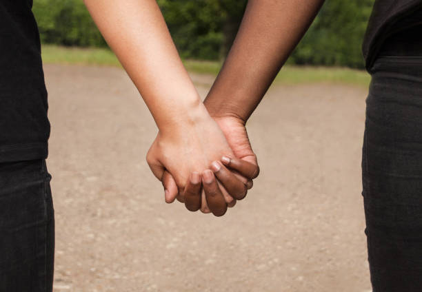 istock Joined black and white hands of friends in cooperation 1248707850