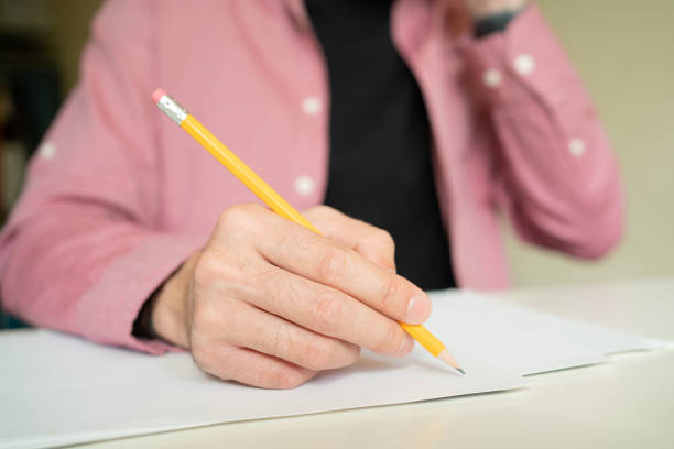 istock Hand holding pencil and drawing on paper 1248708139