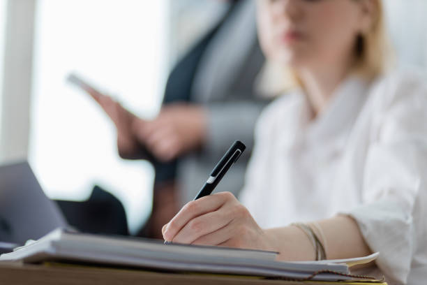 istock Young businesswoman signing a document 1248709747
