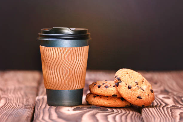 istock Coffe plastic cup and chocolate cookies on wooden background 1248714184