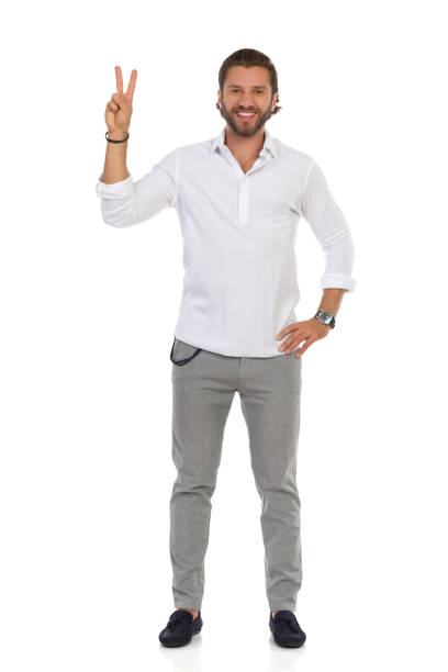 istock Handsome Elegant Man Is Standing And Showing Peace Hand Sign. 1248717024