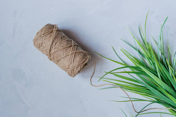 istock long cardboard thread on a light neutral background with artificial green grass 1248717114