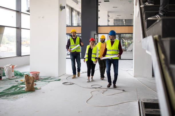 istock Team of architects walking through building and talking about work progress 1248722769
