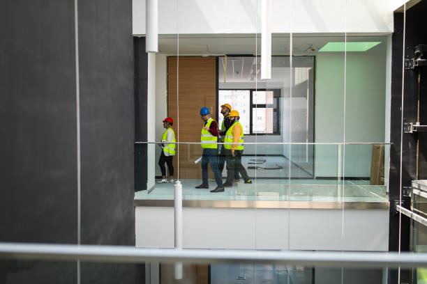 istock Architects and engineers discussing about work inside nearly finished building 1248722784
