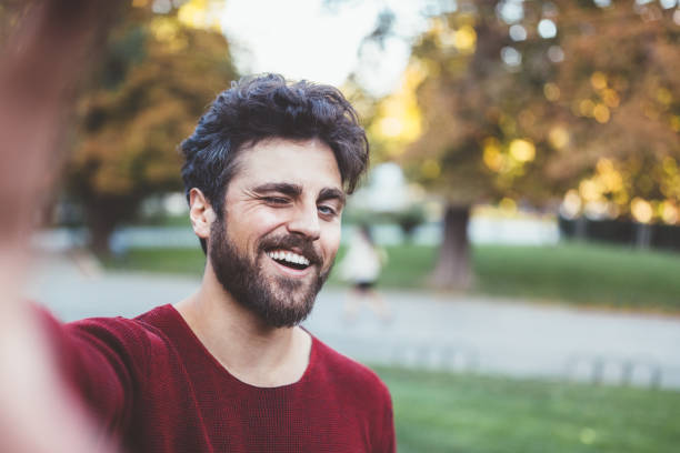 Selfie Young man taking selfie young man wink stock pictures, royalty-free photos & images