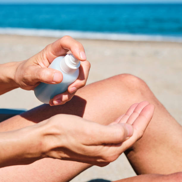 istock man on the beach disinfecting his hands 1248726078