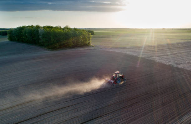 istock Aerial view of tractor working in field 1248726878