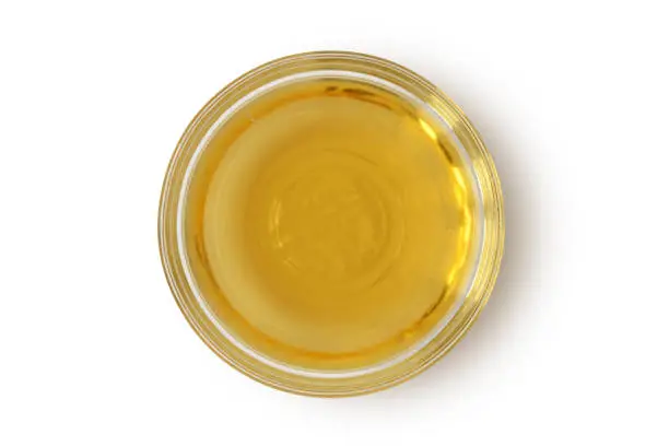 Apple cider vinegar in glass bowl on white background