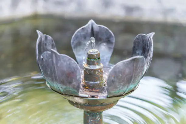 Medieval forged metal flower fountain with small water fountain, Germany