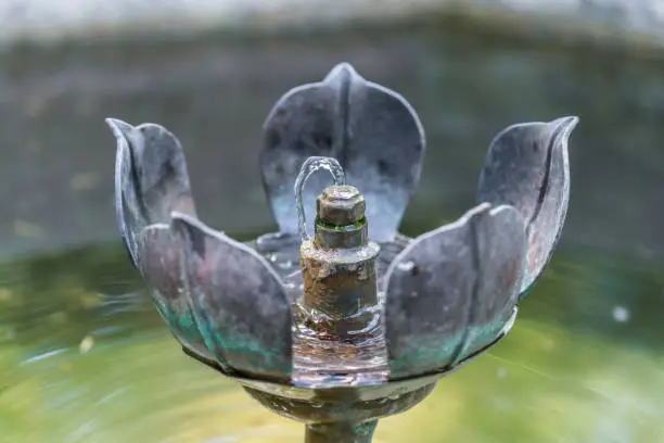 Medieval forged metal flower fountain with small water fountain, Germany