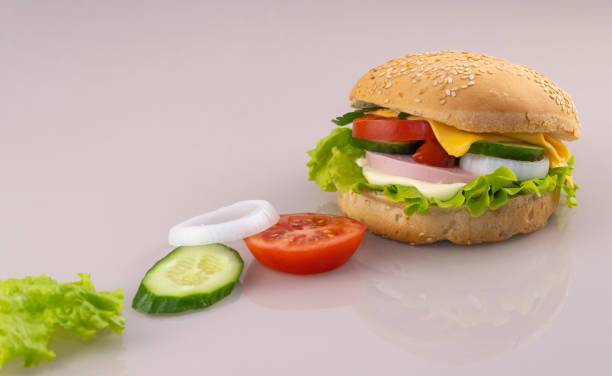 istock making sandwiches for breakfast. delicious burger on a glass surface with reflection. concept of making fast food. copy space 1248728325