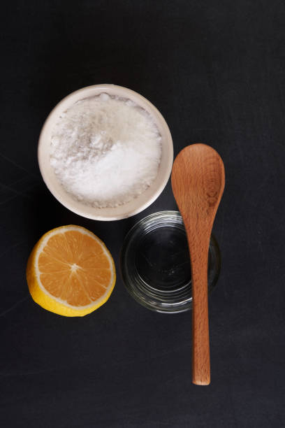 baking soda vinegar and lemon top view of baking soda and vinegar on blackboard carbonate mineral stock pictures, royalty-free photos & images