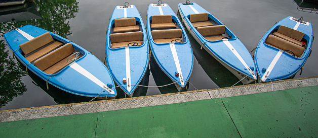 Little boats in nice colors at a lake in austria waiting for passengers