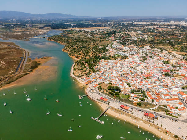 Aerial view of nature and city of Alvor, Algarve, Portugal Aerial view of bay with yachts and city of Alvor, Algarve, Portugal faro district portugal photos stock pictures, royalty-free photos & images