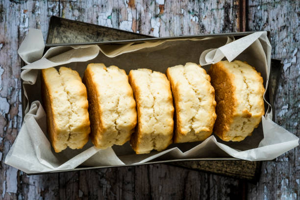 istock Five freshly baked scones in a greaseproof lined metal tin 1248730926