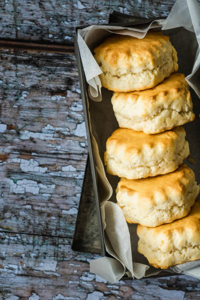 istock Five freshly baked scones in a greaseproof lined metal tin 1248730960