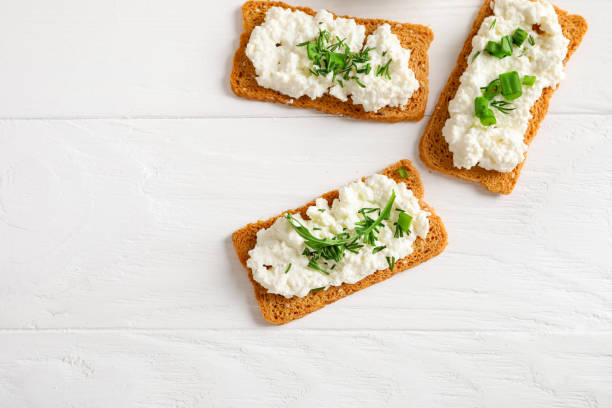istock Healthy and tasty snack with crispy bread, cottage cheese and herb 1248732011
