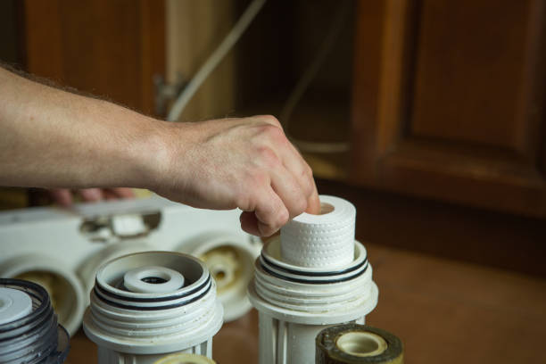 istock Changing filters in your home water purification system. The master puts clean filters in flasks for later installation. 1248733577