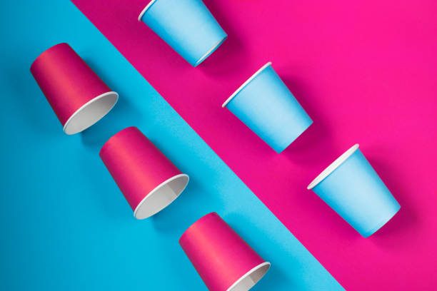 istock Pattern of paper cups located diagonally on a pink-blue background. Ecological tableware. Minimalistic style. 1248734254