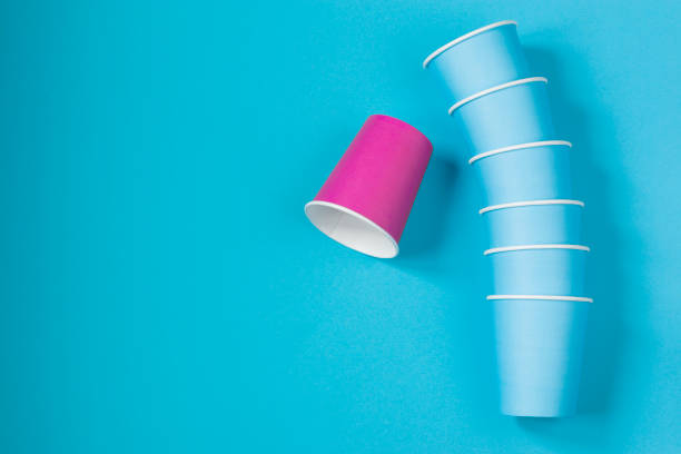 istock Paper cups on a blue background. Ecological tableware. Minimalistic style. Top view. 1248734255