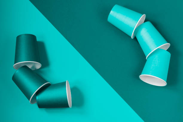 istock Pattern of paper cups located diagonally on a mint background. Ecological tableware. Minimalistic style. 1248734262