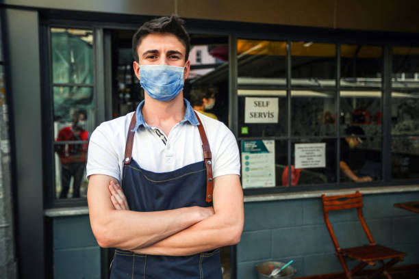 istock New Normal, Opened Cafes and Masked Waiter 1248735116