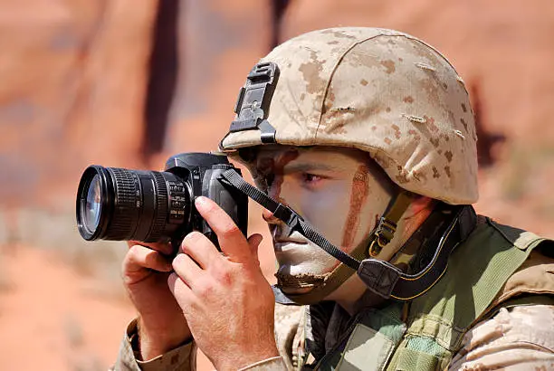 Lone Marine In Desert and Desert Camouflage With Camera During Reconnaissance Mission