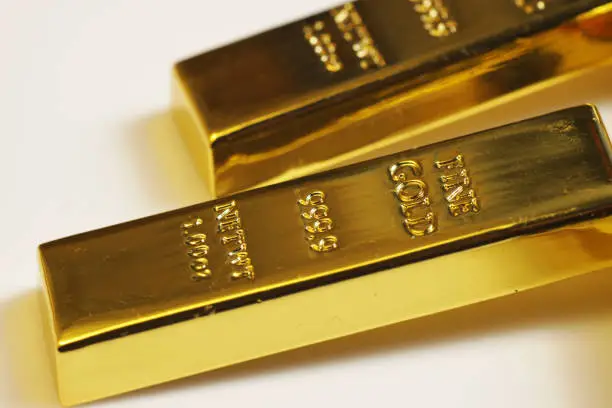 Close up shot of stacked 999.9 pure gold bar ingot on a white background, represented the business, invesment and finance concept idea