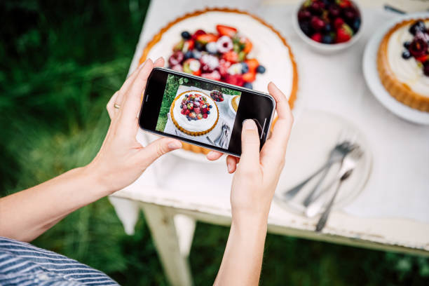 woman photographing freshly made fruit cake - filming point of view fotos imagens e fotografias de stock