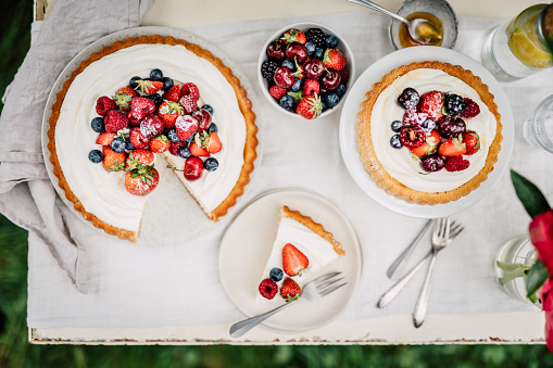 Directly above shot of freshly made fruit cake on table. Cake made of cream cheese, blackberries, raspberries and strawberries.