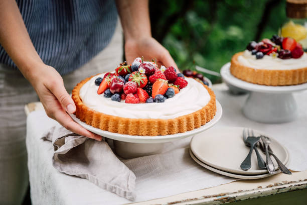 Woman setting up cake table outdoors