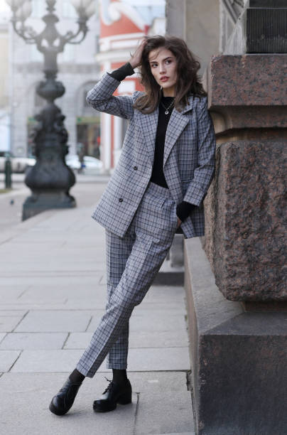 istock Beautiful girl in a checked pantsuit 1248736584