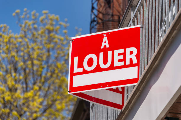 A Rent sign (For rent in french) posted in front on balcony fence stock photo