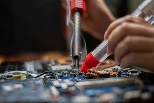 istock Close-up hand technician repairing broken laptop notebook computer with electric soldering Iron 1248737449