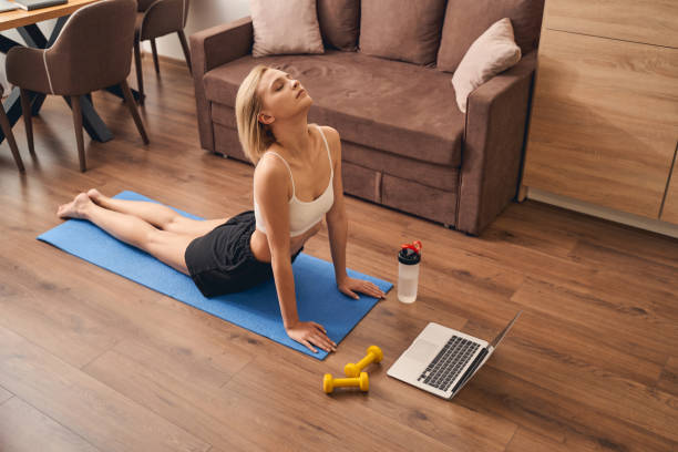 istock Blonde woman practicing an upward-facing dog exercise 1248737585