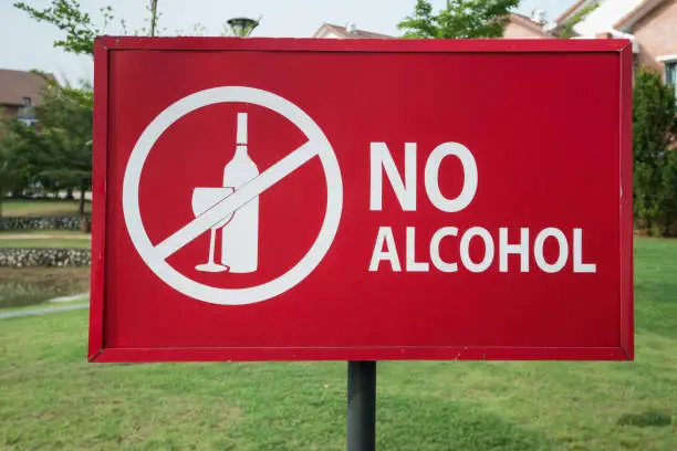 Close-up of the no alcohol sign in the park near residential area.